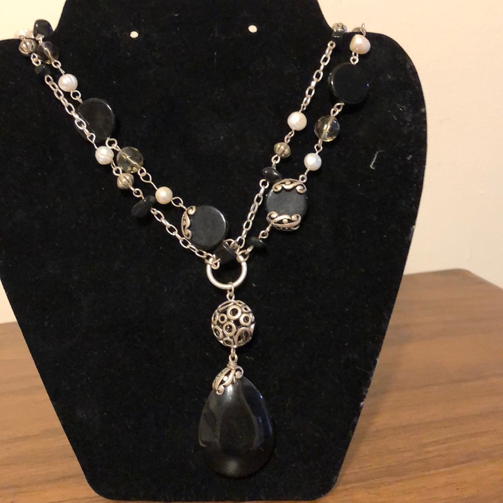 Black stone with white beads